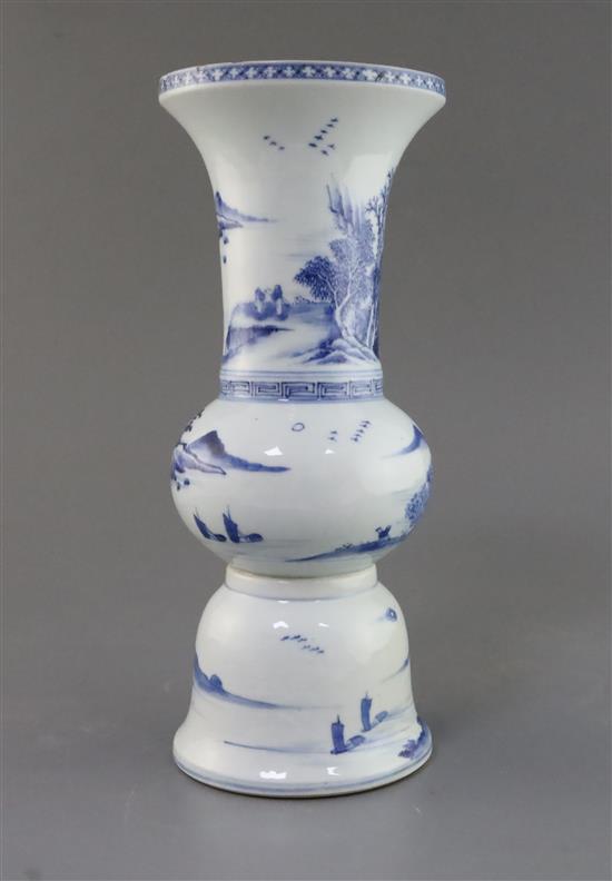 A Chinese blue and white beaker landscape vase, gu, Kangxi period, H. 30.5cm, lean to one side